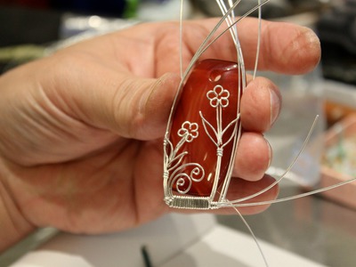 The making of a wire wrapped pendant - silver daisies on a red agate gems bead