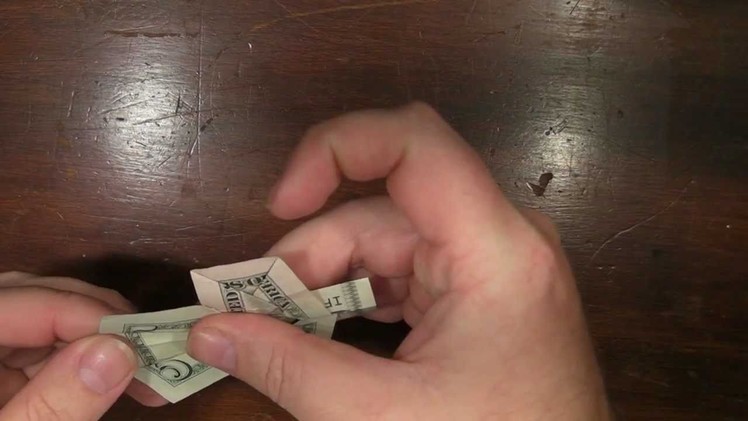 Origami Cross with a US five dollar bill