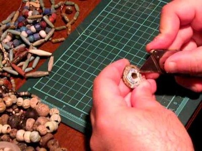 Cleaning Ancient Glass Beads from dirt using a cutter to Show the real Patina