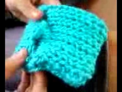 Kadi showing her cell phone holder bag she made loom knitting