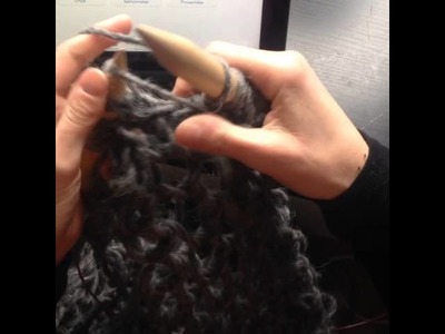 Knitting scarf with big needles.