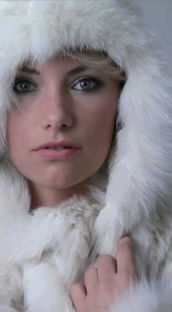 Lady in knitted fur coat with big fur hood