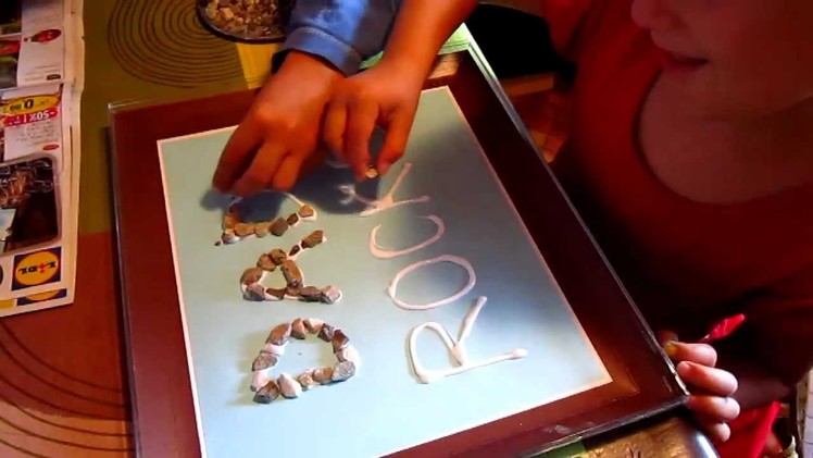 Arts and Crafts project, to make for Father's Day: A "Dad Rocks" poster with small pebbles.