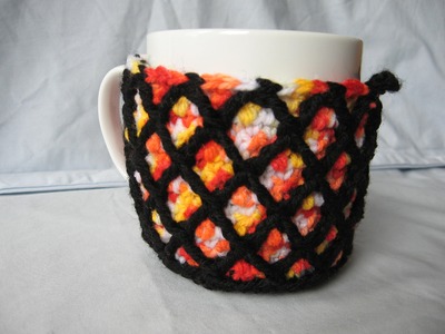 Stained glass lattice crochet mug cosy .
