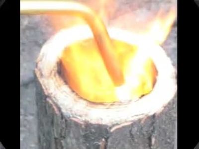Crafting a cup from a log of hardwood.