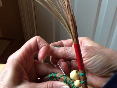 Inserting beads into pine needle baskets