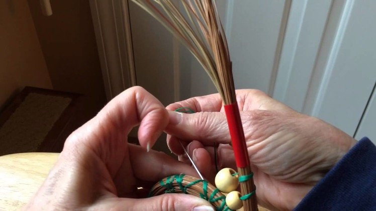 Inserting beads into pine needle baskets