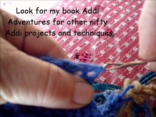 Neatening the edge of an Addi flate panel of knitting