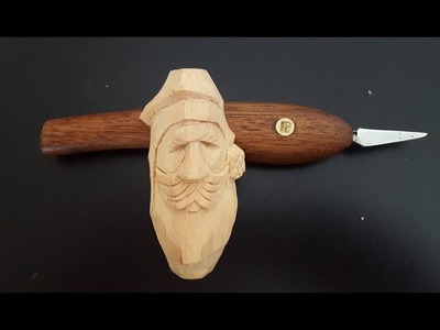 Carving a Santa Claus with detail knife.
