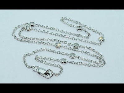 White gold chain interspersed with bezel  settings for diamonds