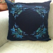 Black velvet cushion with floral print design and turquoise back