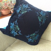 Black velvet cushion with floral print design and turquoise back