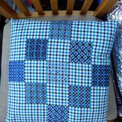 Blue gingham cushion with blackwork embroidery