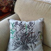 Cotton beige cushion with embroidery flower detail on drawn sketch