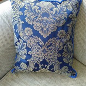 Damask blue cushion with piped edging