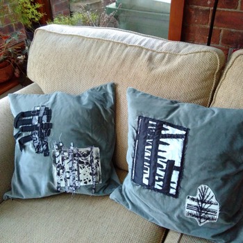 Pair of green velvet cushions with applique embellishment