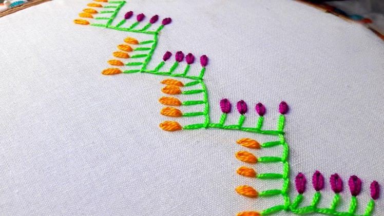Hand embroidery: feather with lazy daisy stitch border design.