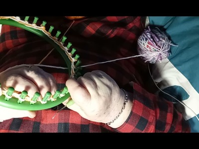 A scrappy hat made on a round loom.