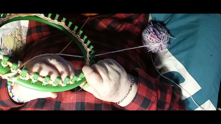 A scrappy hat made on a round loom.