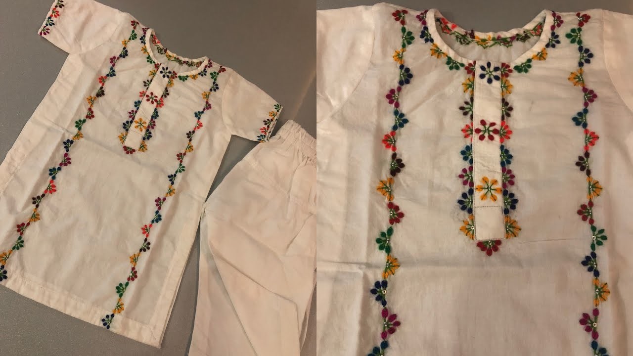 Multi coloured hand embroidery on white dress