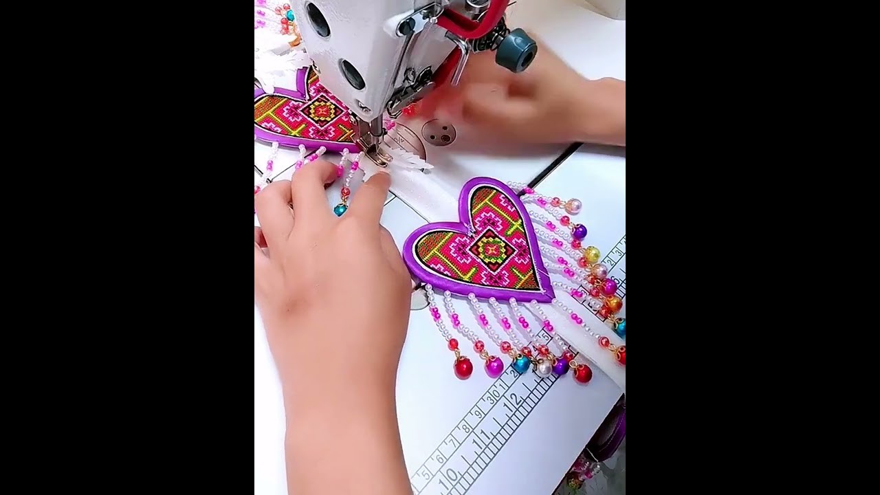 The sewing of an ornament on a girl's skirt