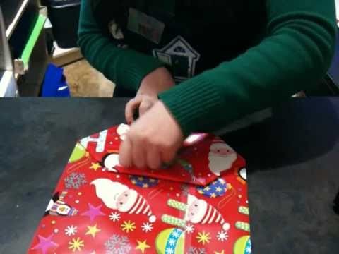 Folding a gift bag at Tree Town Toys
