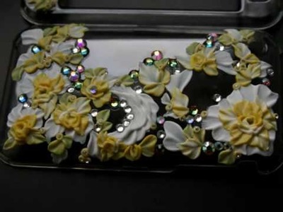 Crystal case for iPhone 3G incrusted with SWAROVSKI and decorated with handmade flowers.