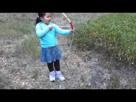 Kids learning to shoot bow and arrow