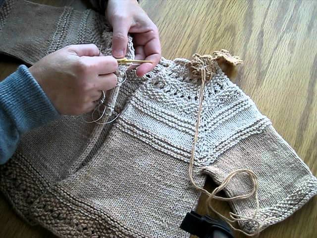 Sewing a button on a Knitted sweater