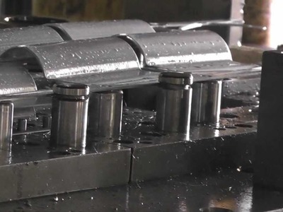 Progressive tool; pole clamp stamping