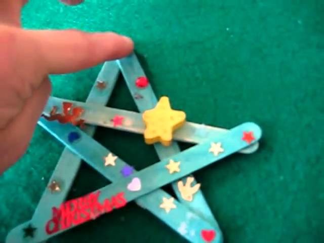 Christmas. Arts and Crafts activity: colored Popsicle sticks and stickers star decorations.