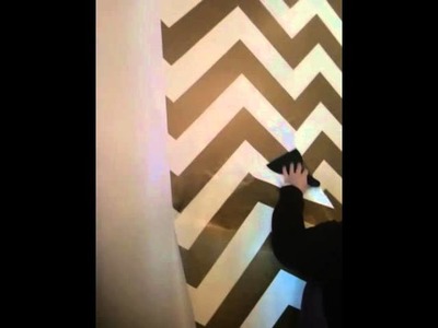 Interior Designer, Kent, is installing temporary chevron wall paper at Blue Hand Home!
