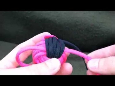 Paracordist how to TIGHTEN a two color monkey's fist knot made with paracord and a jig