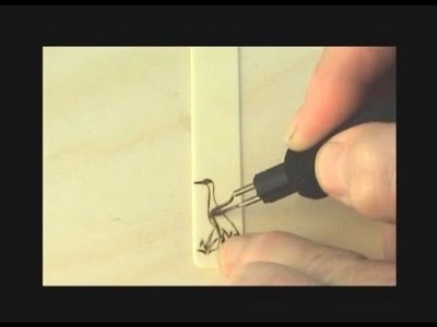Burning on an old piano key to make a unique bookmark.