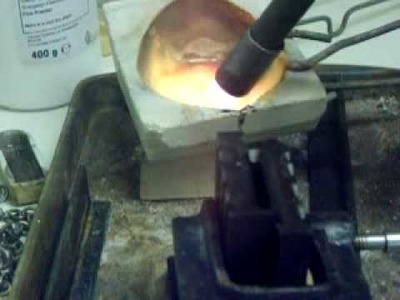 Melting silver and pouring to make ingot.