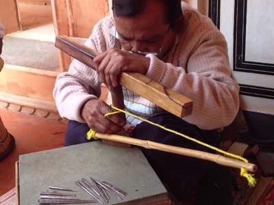 Hand-carving a wooden textile stamp, India