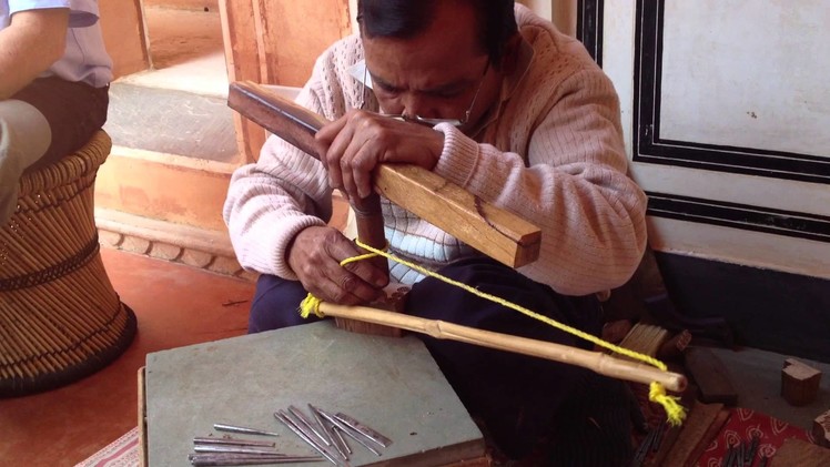 Hand-carving a wooden textile stamp, India