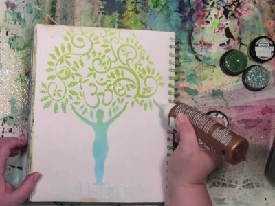 Stencils and spray inks with a touch of glitter in an art journal