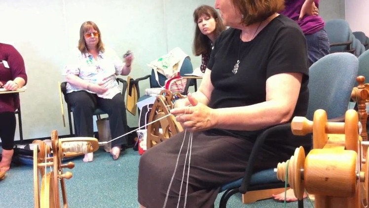 Judith Mackenzie demonstrating how to ply three-ply yarn