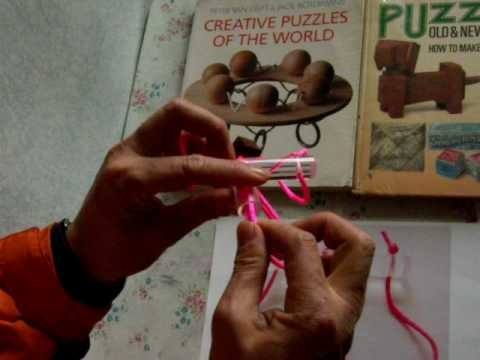One version of African ball and string puzzle