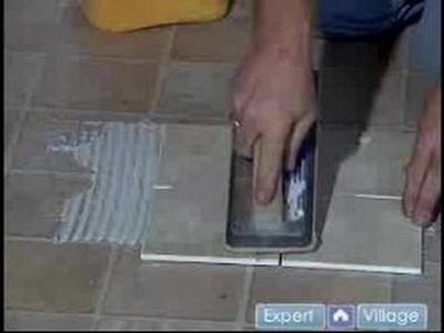 How to Install Flooring in Your Basement : Applying Grout to Install New Flooring in Your Basement