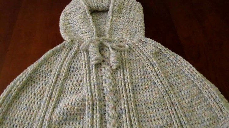 Crochet child hooded poncho with cable stitch