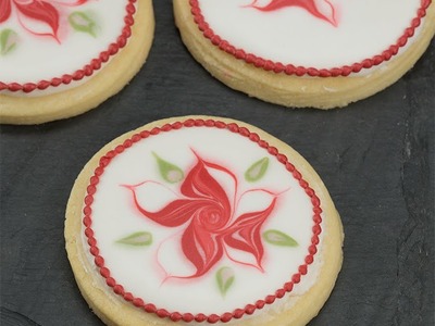 Learn How to Pipe a Wet on Wet Poinsettia on a Sugar Cookie