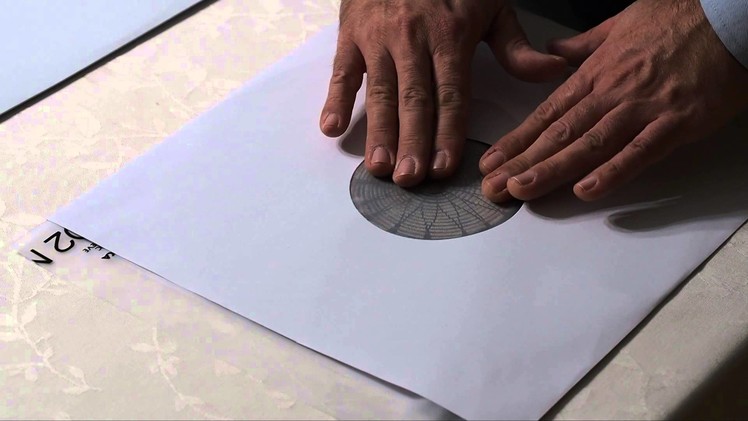 How to remove vinyl record from unlined paper sleeve without causing any scratches on the record