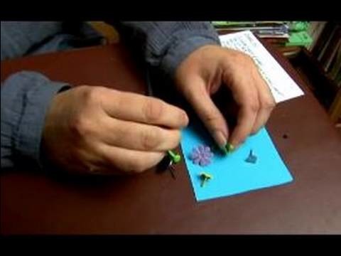 How to Use Embellishments in Scrapbooking : How to Add Brads to Scrapbooks