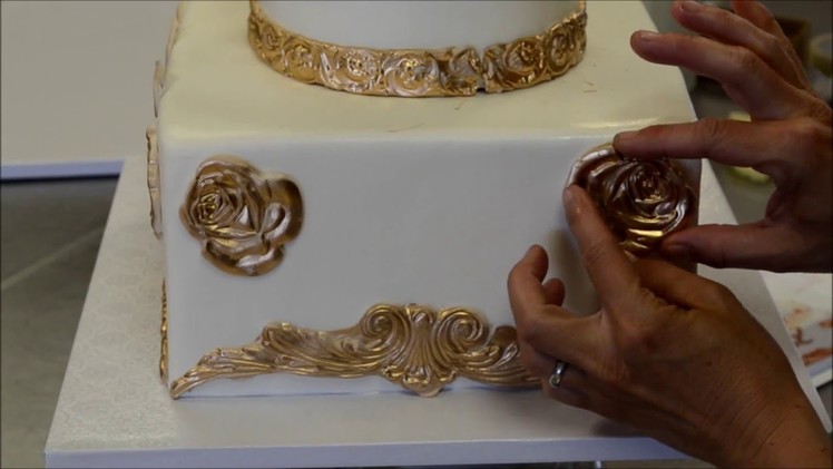 How to decorate a tiered cake in gold