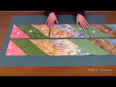 Create an impressive quilt top with fabric strips and straight stitches