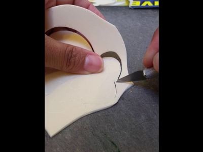 Handcutting a Mickey Mouse face out of craft foam