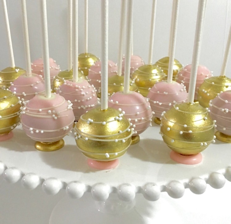 Upside down pink & gold Cakepops with flat bottom base and stripes.swirls design