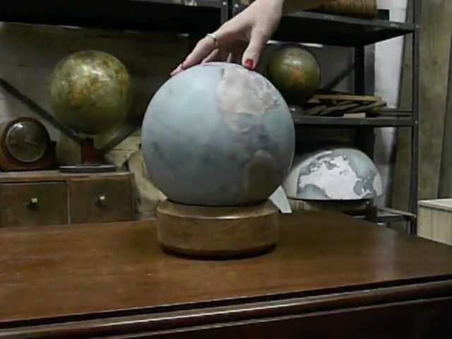 Mini desk globe being spun by hand
